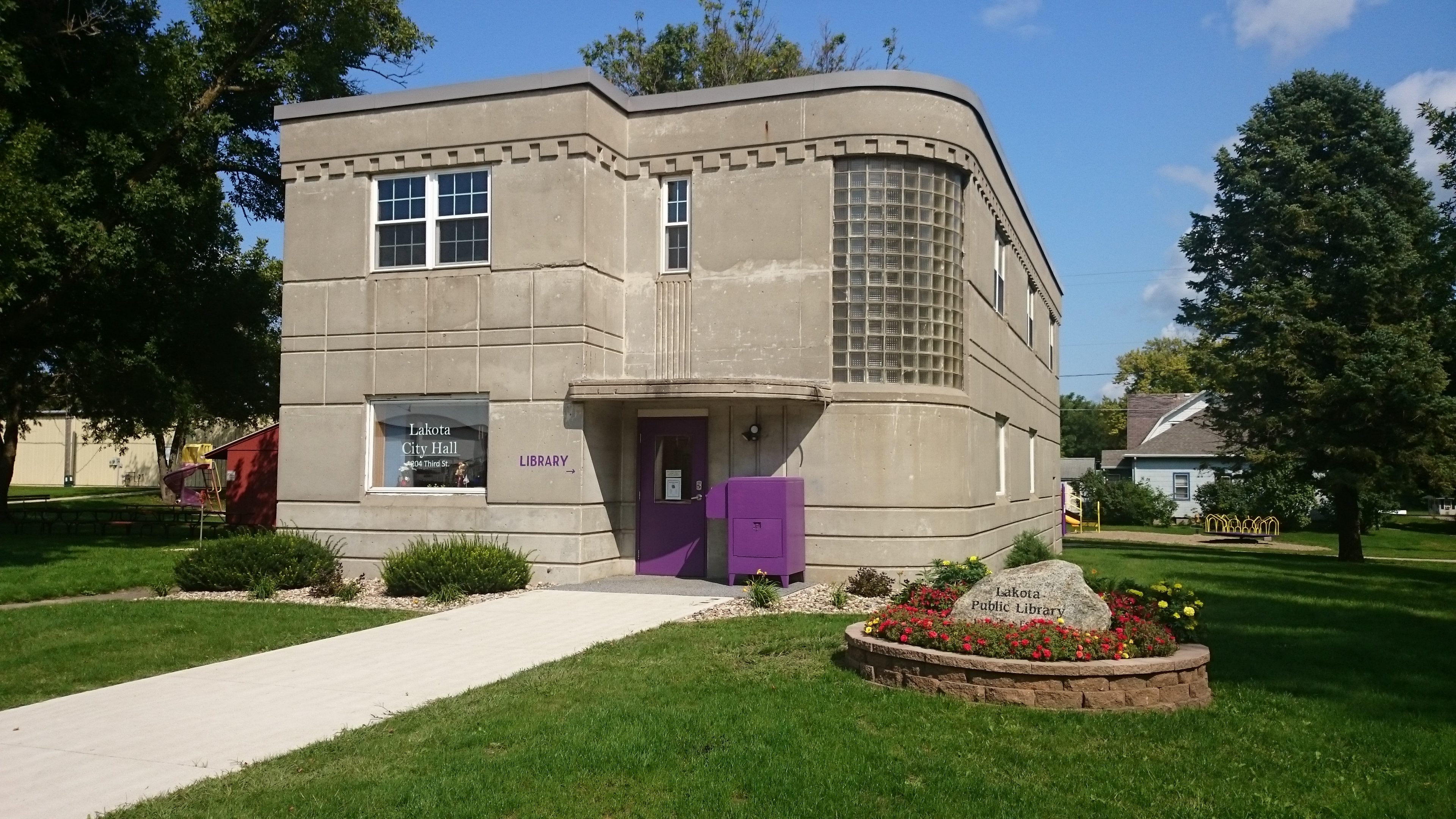 library building with grass and and trees in background